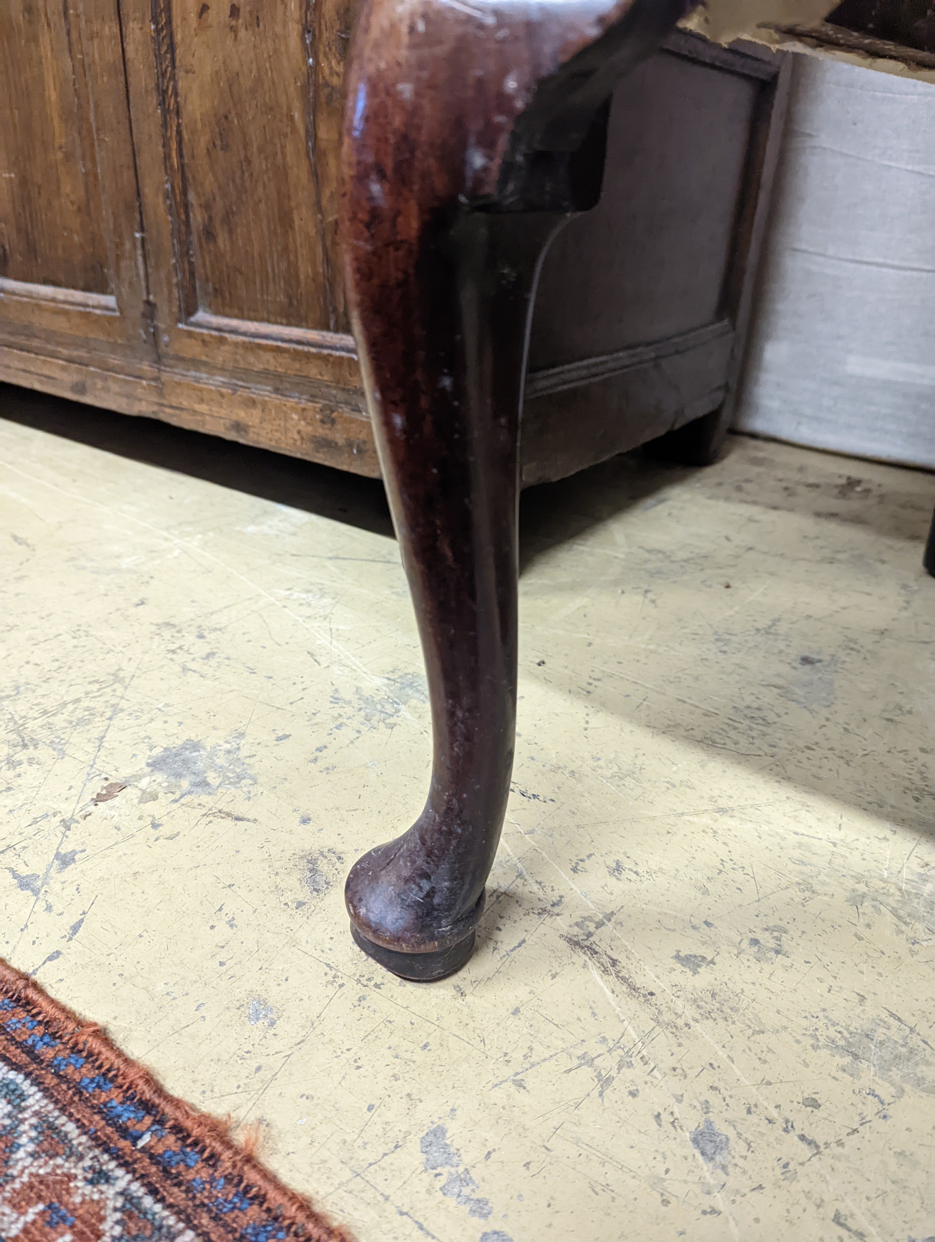 A George II mahogany wingback armchair, with slender cabriole legs and pad feet, width 80cm, depth 66cm, height 126cm